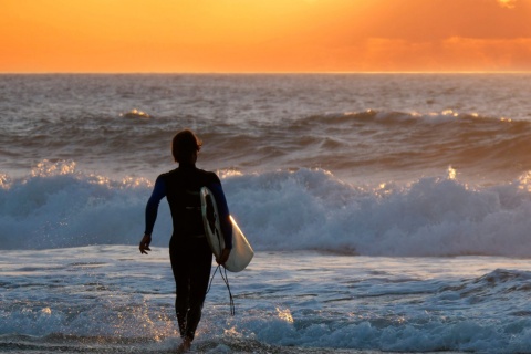 Surfer betrachtet den Sonnenuntergangs auf Fuerteventura auf den Kanarischen Inseln