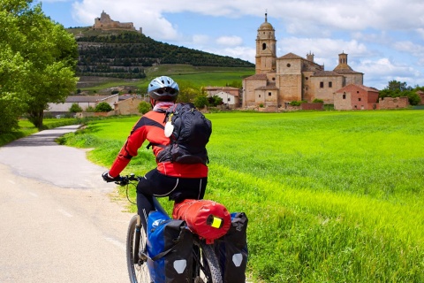 Pilgrim on a bicycle arriving in Castrojeriz (Burgos)