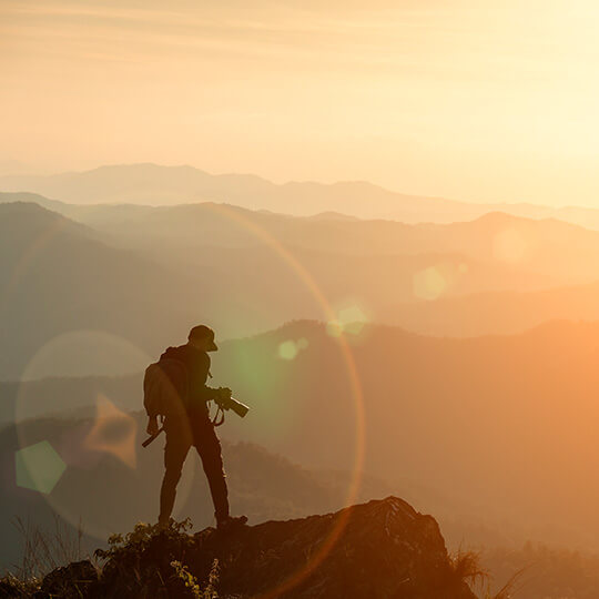 Photographer at the top of a mountain