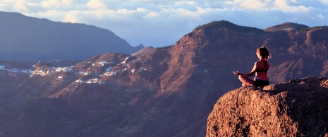 Woman doing yoga in the mountains of La Palma (Canary Islands).