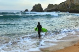 Surfer at Laga beach in Vizcaya, the Basque Country