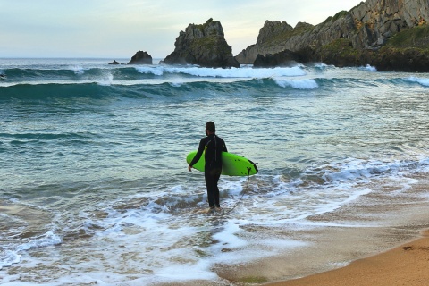 Surfer at Laga beach in Vizcaya, the Basque Country