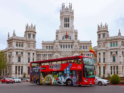 Madrid tourist bus going through Plaza de Cibeles 