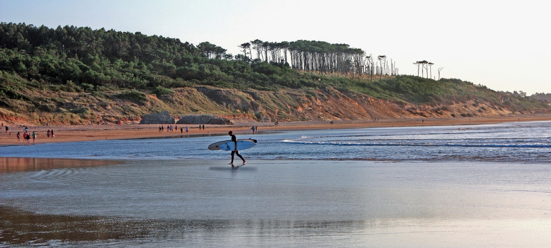 A surfer on Somo beach in Cantabria