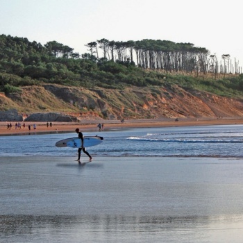 A surfer on Somo beach in Cantabria