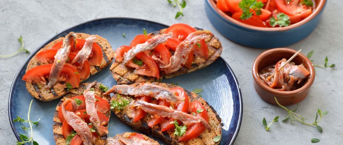 Anchovies with tomato and bread Anchovies with tomato and bread