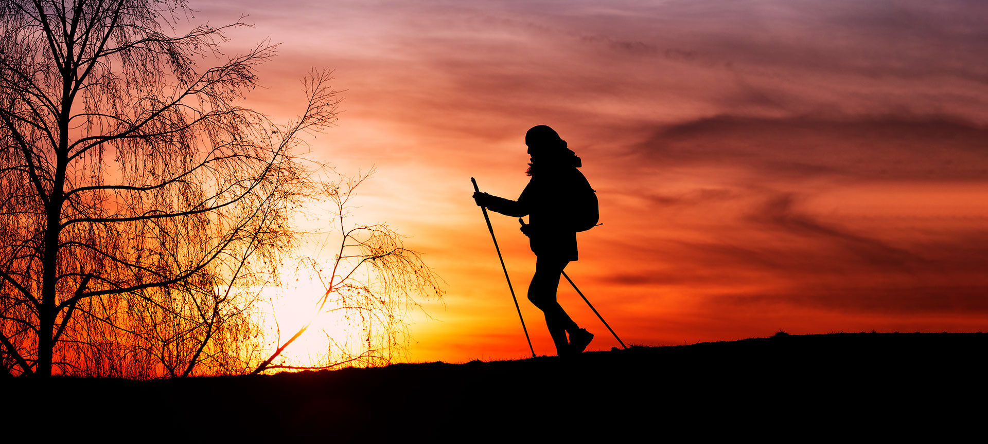 Sylwetka kobiety na szlaku pielgrzymkowym o zachodzie słońca