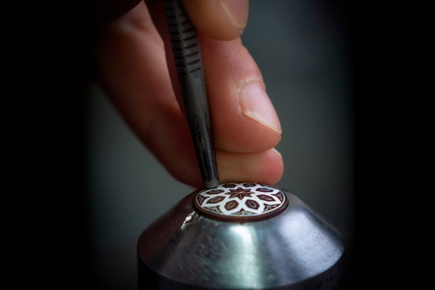 Detail of a craftsman embellishing a piece using the damascene technique