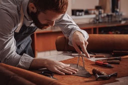 Craftsman working with leather