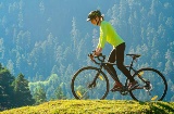 Woman enjoying a spot of cycle tourism in the countryside