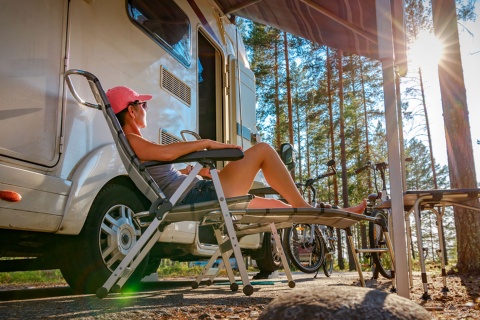 Tourist relaxing outside a caravan