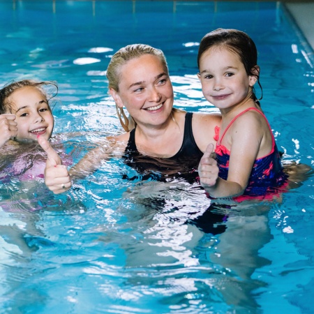 Family enjoying themselves in the swimming pool