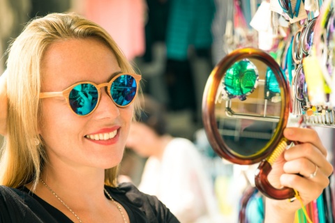 Tourist trying on glasses at a street market