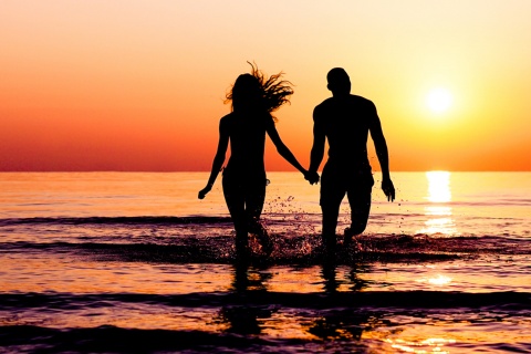 Couple enjoying sunset on the beach