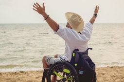 Person with disability in a wheelchair on the beach