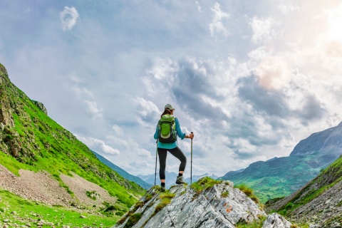 Hiker admiring the views on a route through the Pyrenees