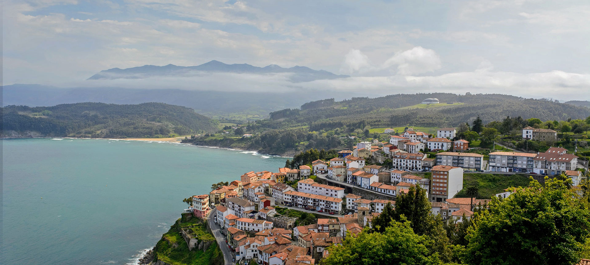 View of Lastres with the sea and Los Picos de Europa mountains in the background. Asturias