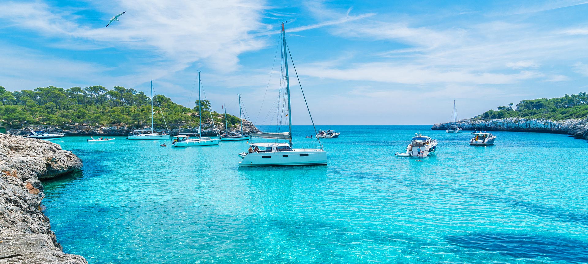 Boats in the turquoise waters of Mondragó Cove. Majorca