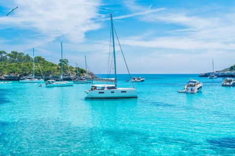 Boats in the turquoise waters of Mondragó Cove. Majorca
