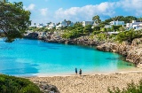 Tourists at Cala Esmeralda, located in Cala d’Or in Mallorca, Balearic Islands