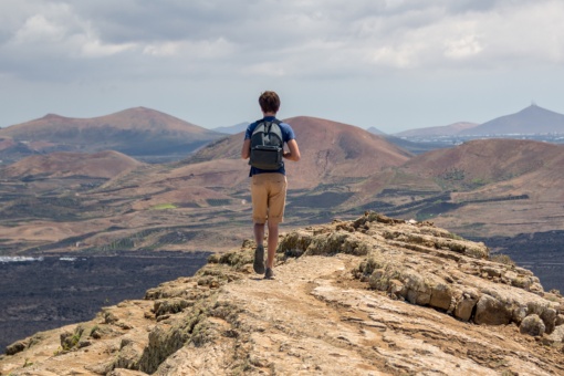 Tourist walking on route to Caldera Blanca in Lanzarote, Canary Islands