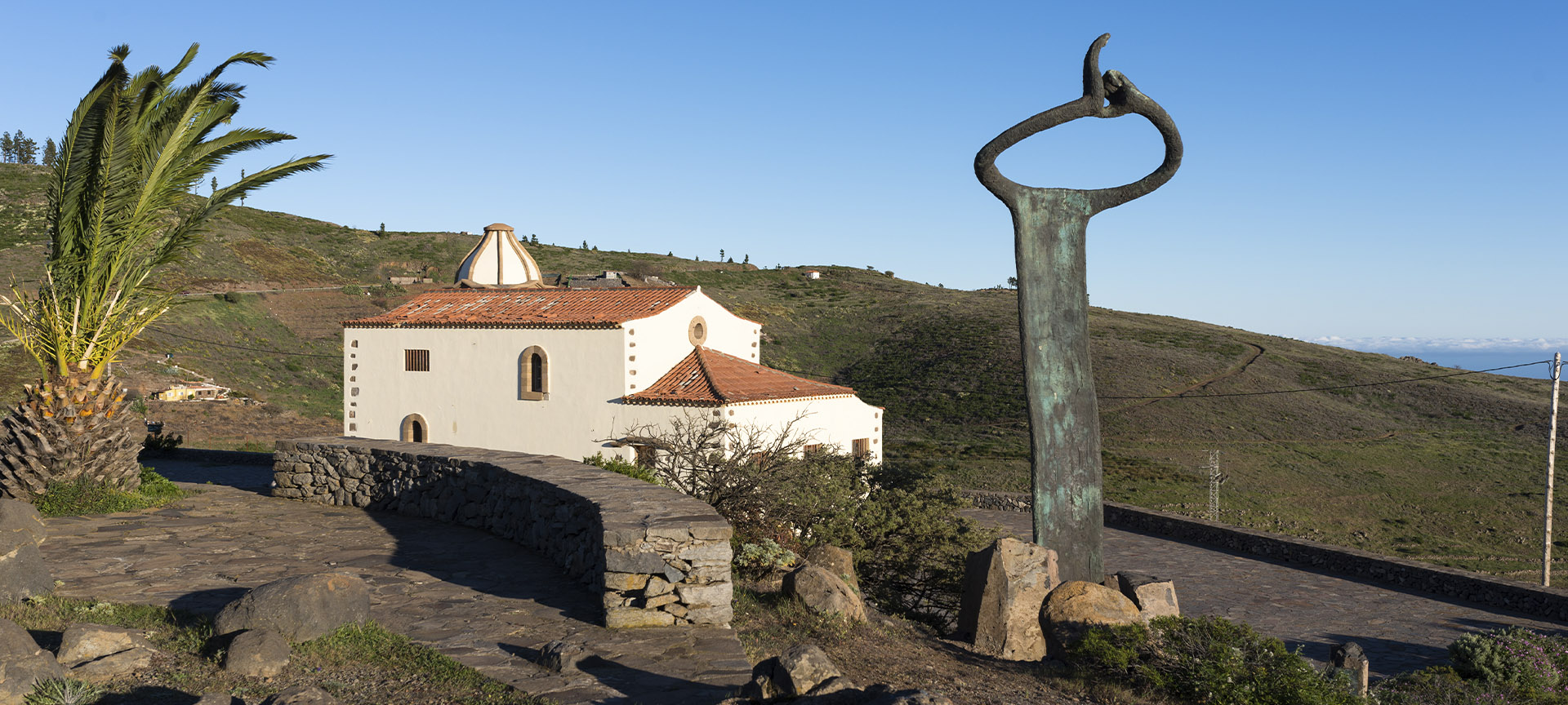 Monument to the whistled language and Church of San Francisco in Chipude (La Gomera, Canary Islands)