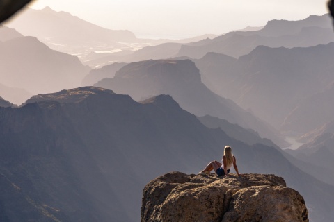 Woman admiring the scenery near Roque Nublo in Gran Canaria, Canary Islands