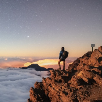 Tourist contemplating the sky from the viewpoint on the peak of Fuente Nueva in La Palma, Canary Islands