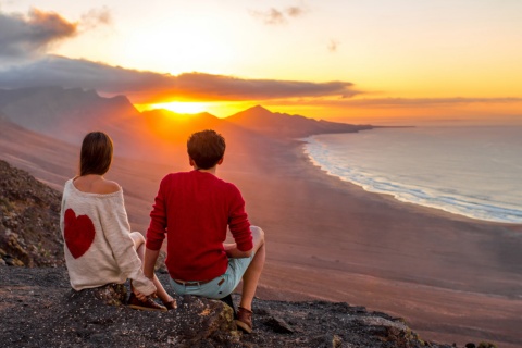 Couple in love looking at the landscape in Fuerteventura (Canary Islands).