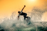 Young man surfing a huge wave in Tenerife, Canary Islands