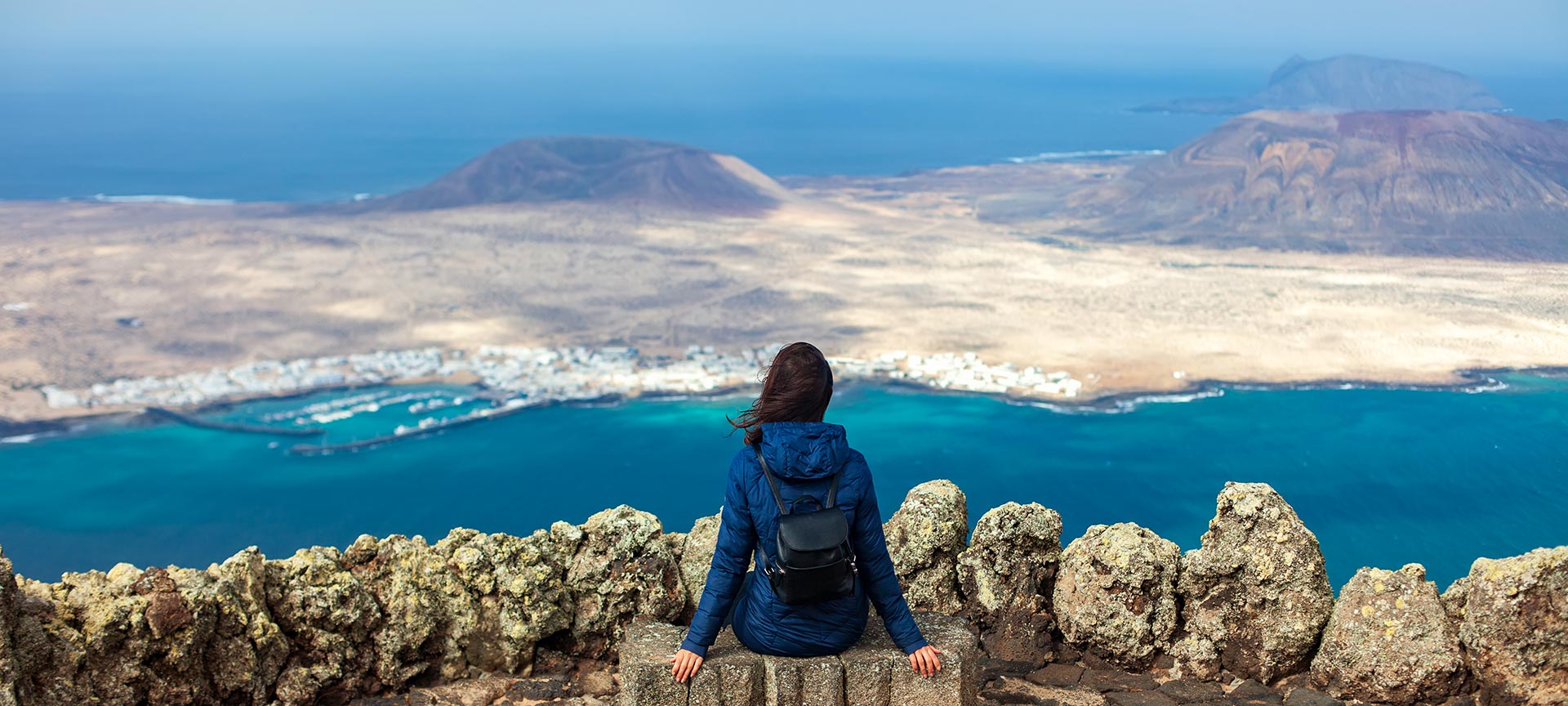 Woman admiring the scenery from the Mirador del Río viewing point. Lanzarote