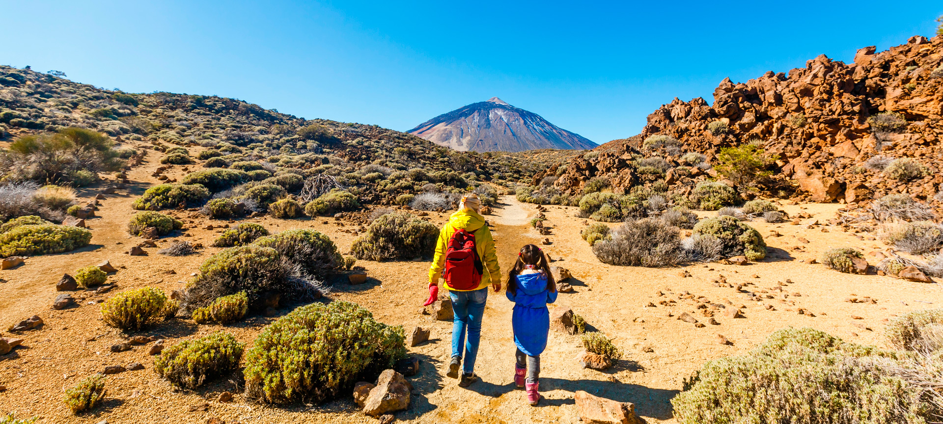 Mother and daughter walking through the Teide National Park, the Canary Islands Mother and daughter walking through the Teide National Park, the Canary Islands