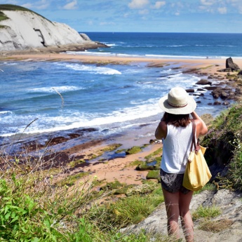 Turista tirando uma foto da praia de Covachos, em Liencres, Cantábria