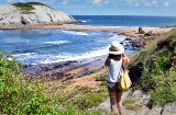Turista che scatta una fotografia della spiaggia di Covachos a Liencres, Cantabria