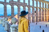 Girl looking at the Roman aqueduct of Segovia