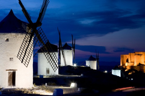 View of the windmills at night, with Consuegra Castle in the background. Toledo
