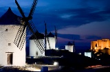 View of the windmills at night, with Consuegra Castle in the background. Toledo