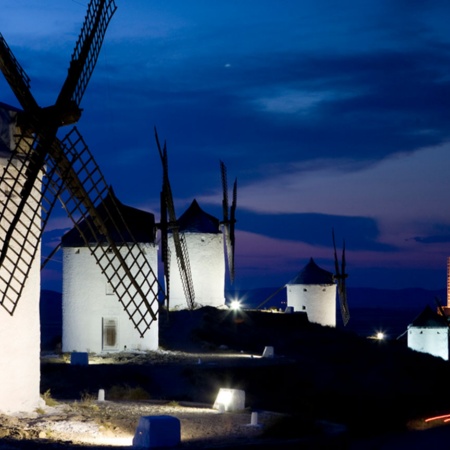 View of the windmills at night, with Consuegra Castle in the background. Toledo