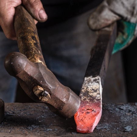 Craftsman working on a sword in a workshop in Toledo.