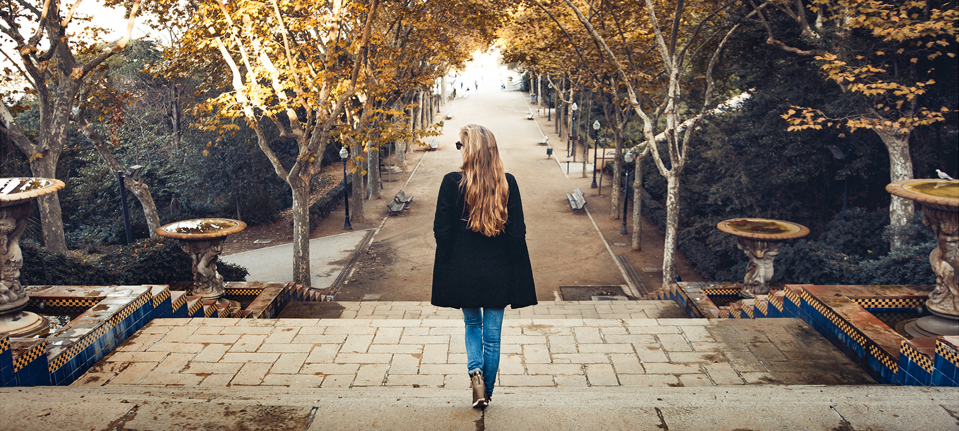 Tourist walking down the steps of a Barcelona park in autumn. Tourist walking down the steps of a Barcelona park in autumn.