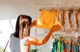 Woman shopping at a stall at the White Summer Festival in Pals, Girona, Catalonia