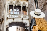 Tourist looking at the Bridge of Sighs in the old town of Barcelona