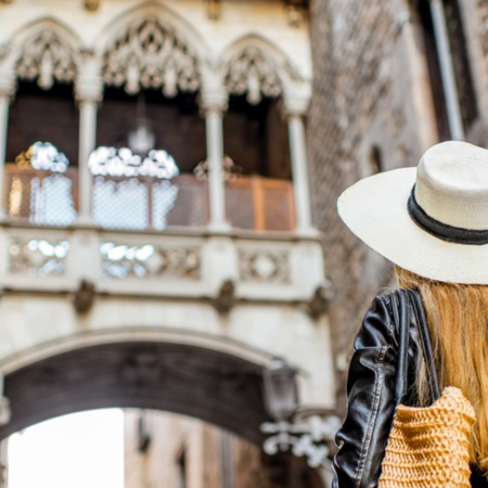 Tourist looking at the Bridge of Sighs in the old town of Barcelona