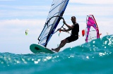 A windsurfer riding a wave.