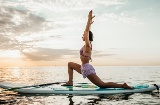 Woman doing yoga on a Sup board