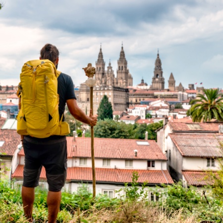 Pilgrim contemplating the Cathedral of Santiago de Compostela in A Coruña, Galicia