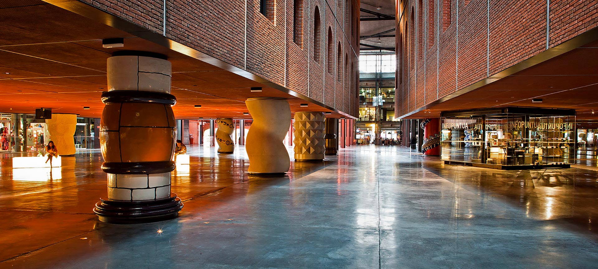 Detailed view of the Azkuna Zentroa cultural center in Bilbao, showcasing its distinctive multi-story architectural columns.