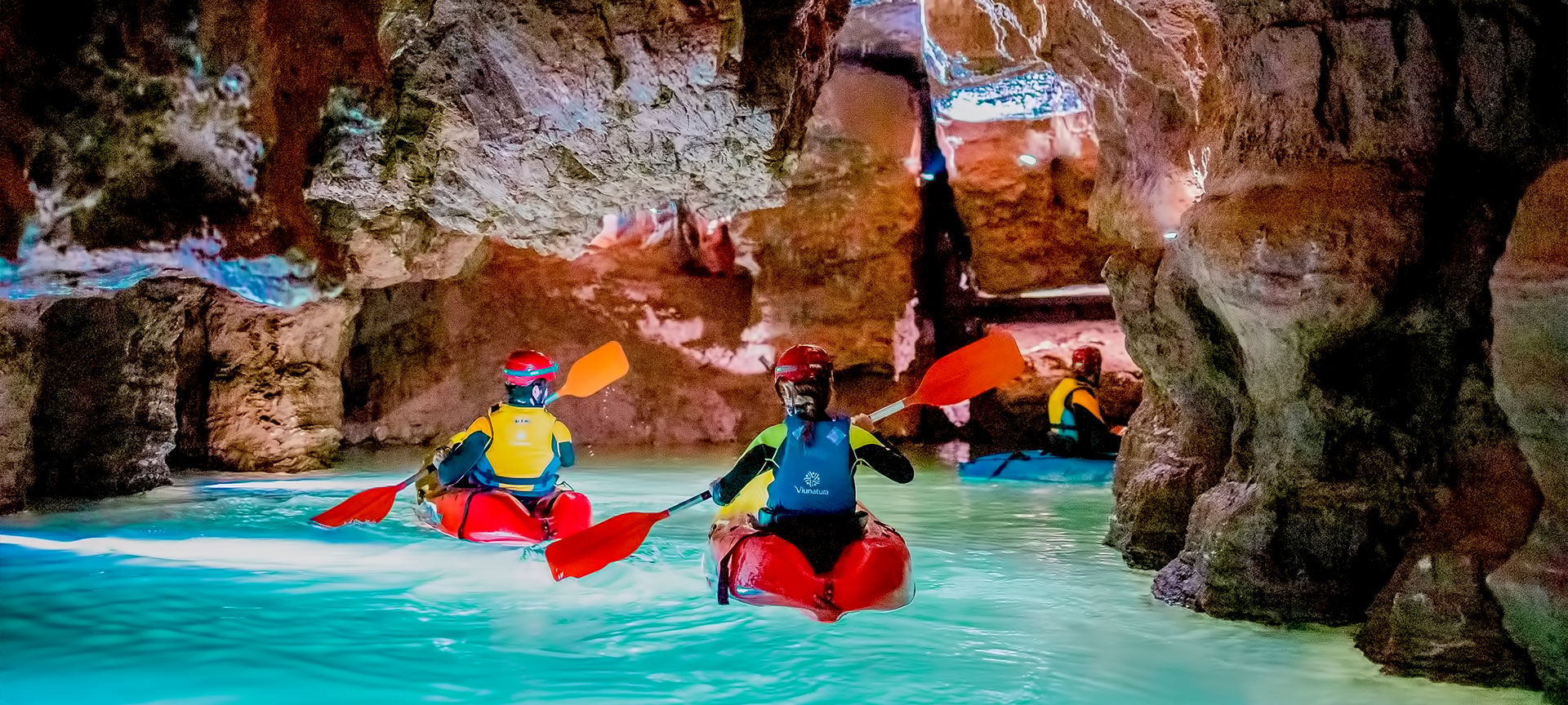 Tourists caving in a kayak in the Coves de Sant Josep de La Vall D'Uixó in Castellon