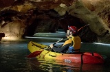 Tourist caving in a kayak in the Coves de Sant Josep de La Vall D