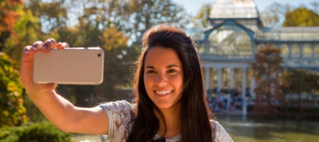 Chica haciéndose un selfie en el Palacio de Cristal del Parque del Retiro, Madrid